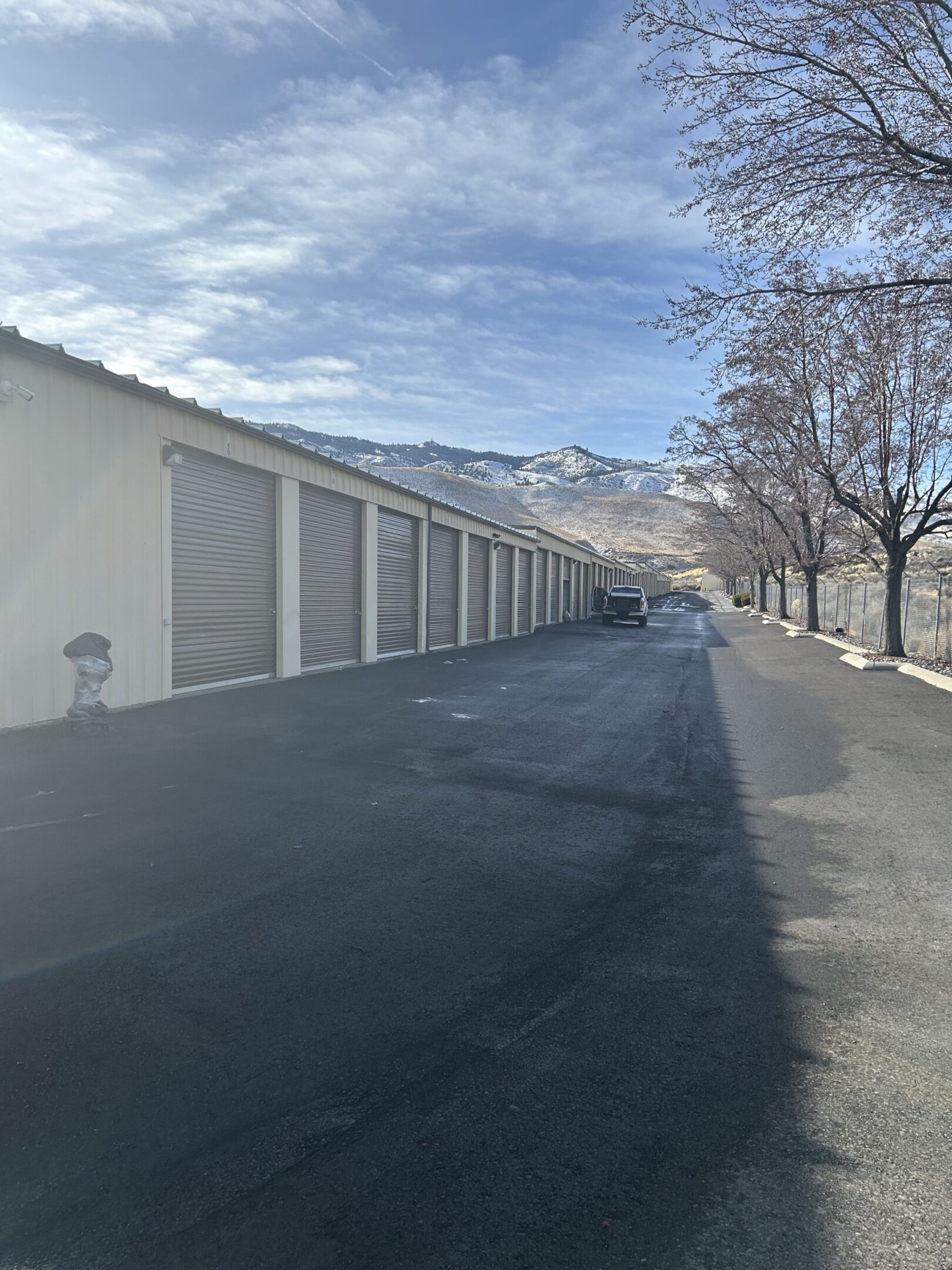 A long row of storage units on the side of a road.