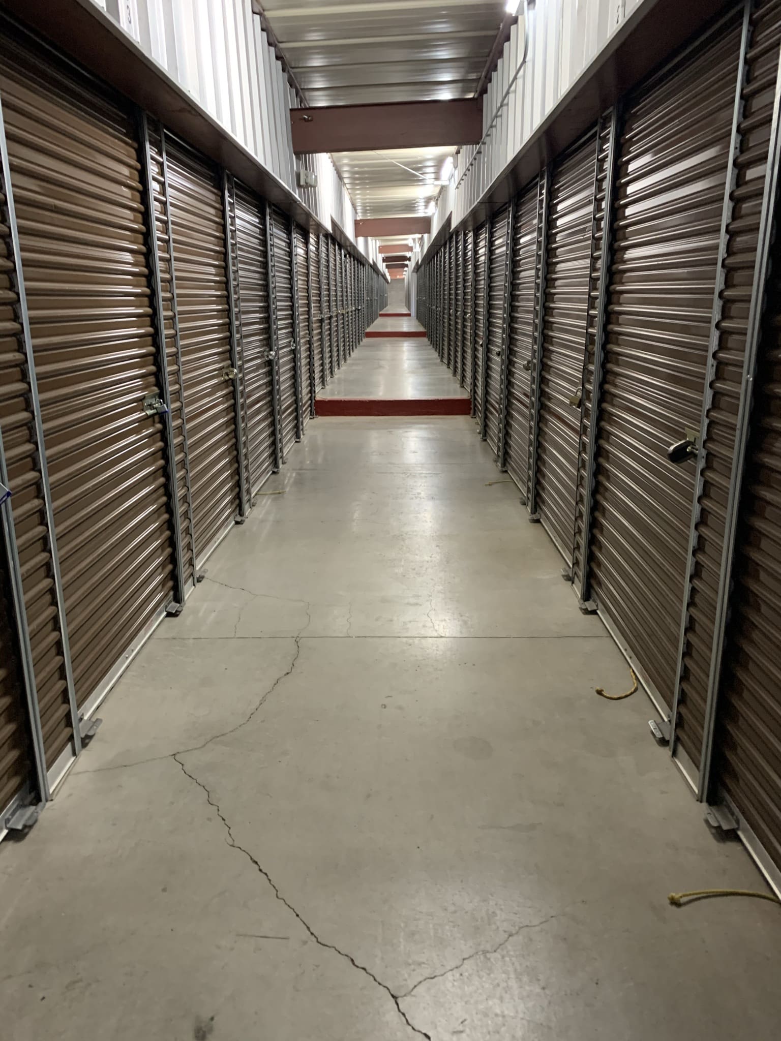 A long hallway with many storage units in it