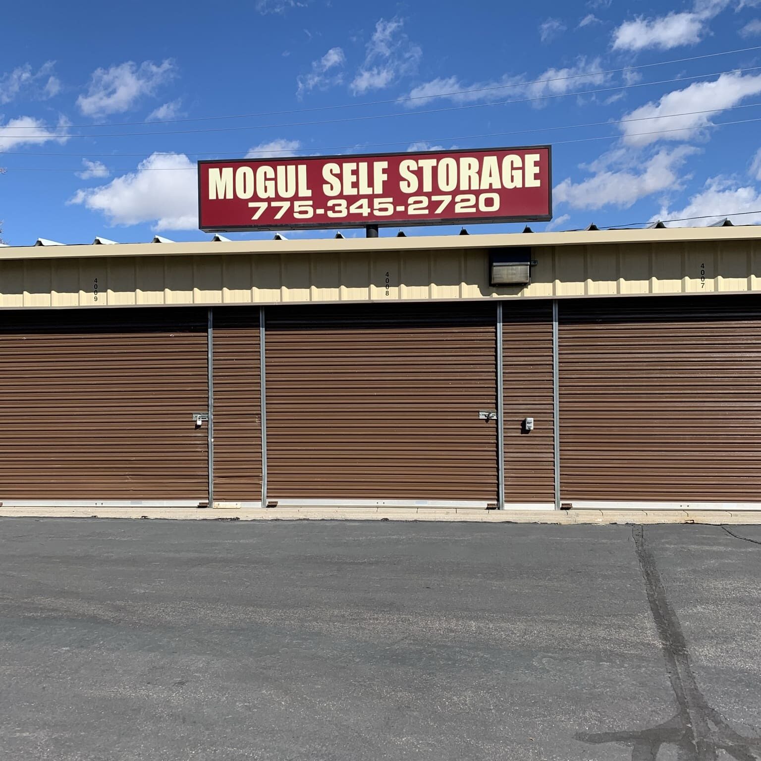 A large storage building with a sign on it.